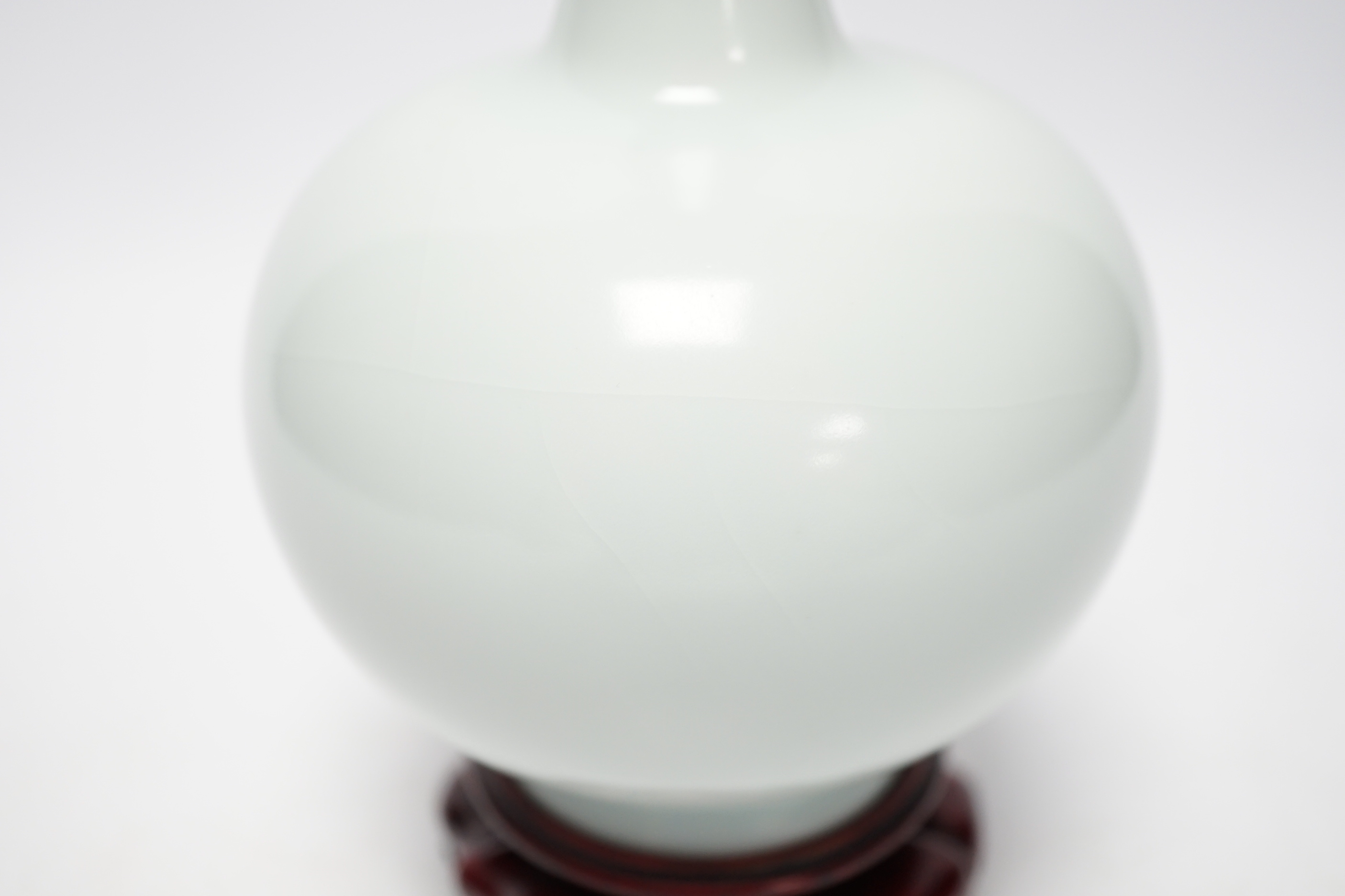 Two modern Chinese blue and white vases on stands, a crackle glaze celadon bowl and vase, tallest 26cm including stand